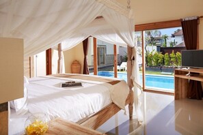 A bedroom with a bed, a bedside table, a TV, and a view of a swimming pool. - Prime location just walking distance to the Boutique shop, Restaurant , Bar (Seminyak)
