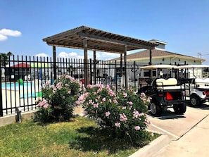 Relax in a serene outdoor setting with a pool and golf facilities nearby.