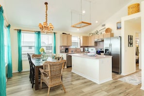 Enjoy cooking in this well-equipped kitchen with a central island, stainless steel appliances, and ample counter space.