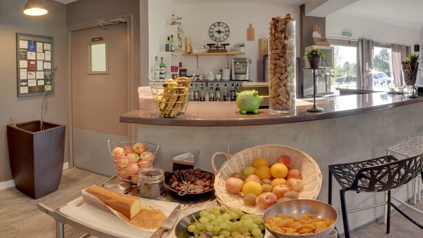 A breakfast buffet with various fruits, bread, and condiments.