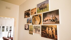 Een kamer met een witte muur waarop verschillende foto's van dieren te zien zijn.