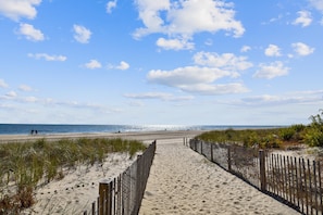 A sandy beach path leading to the ocean with a wooden fence on one side. - XPLORIE ACTIVITIES & LINENS INCLUDED*! OUTDOOR POOL (IN SEASON), TENNIS & MORE!!! (Ocean City)