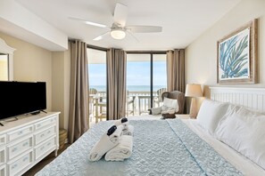 Relax in comfort with a large bed, flat-screen TV, and ocean views from this inviting room.