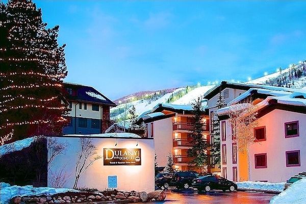 Exterior evening view of the property and night skiing