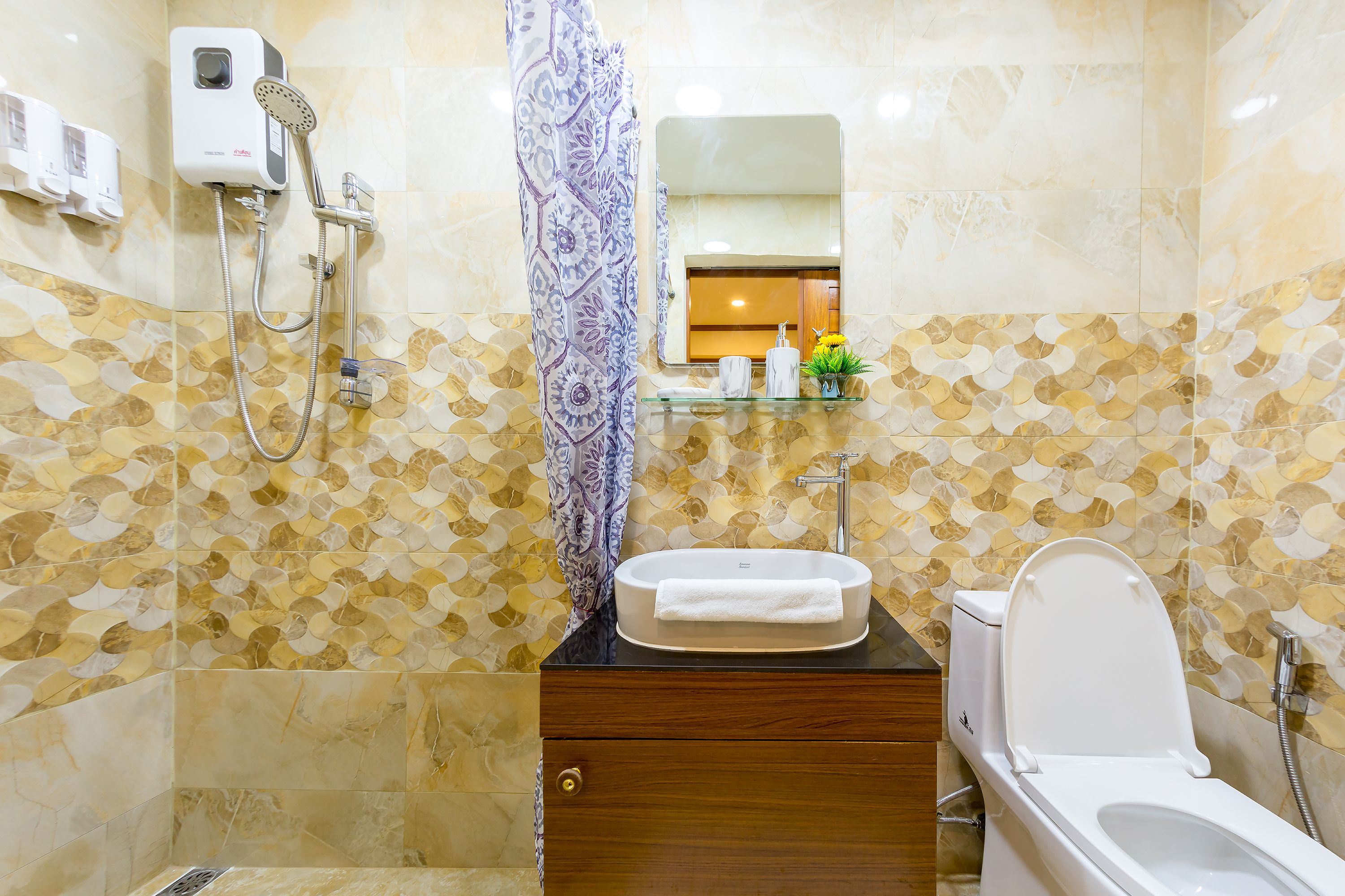 A bathroom with a toilet, sink, and shower.