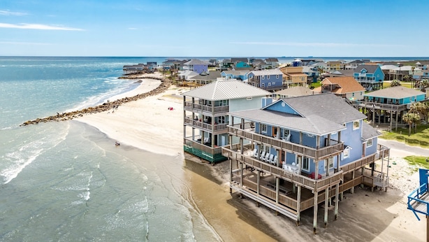 A beachfront property with a multi-story building featuring balconies and a covered deck area. - Atlantis - Oceanfront Seating at its Finest! (Freeport)