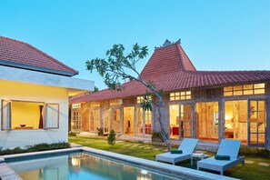 A modern house with a swimming pool, large windows, and a well-maintained garden. - 18min walk to Seminyak Beach,3BDR Villa2 (Seminyak)