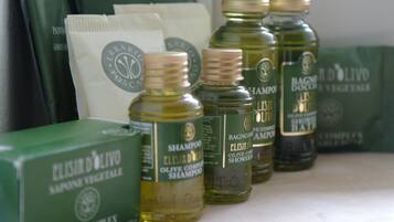 A display of Elisir D'Olivo olive oil products, including shampoo and shower gel.