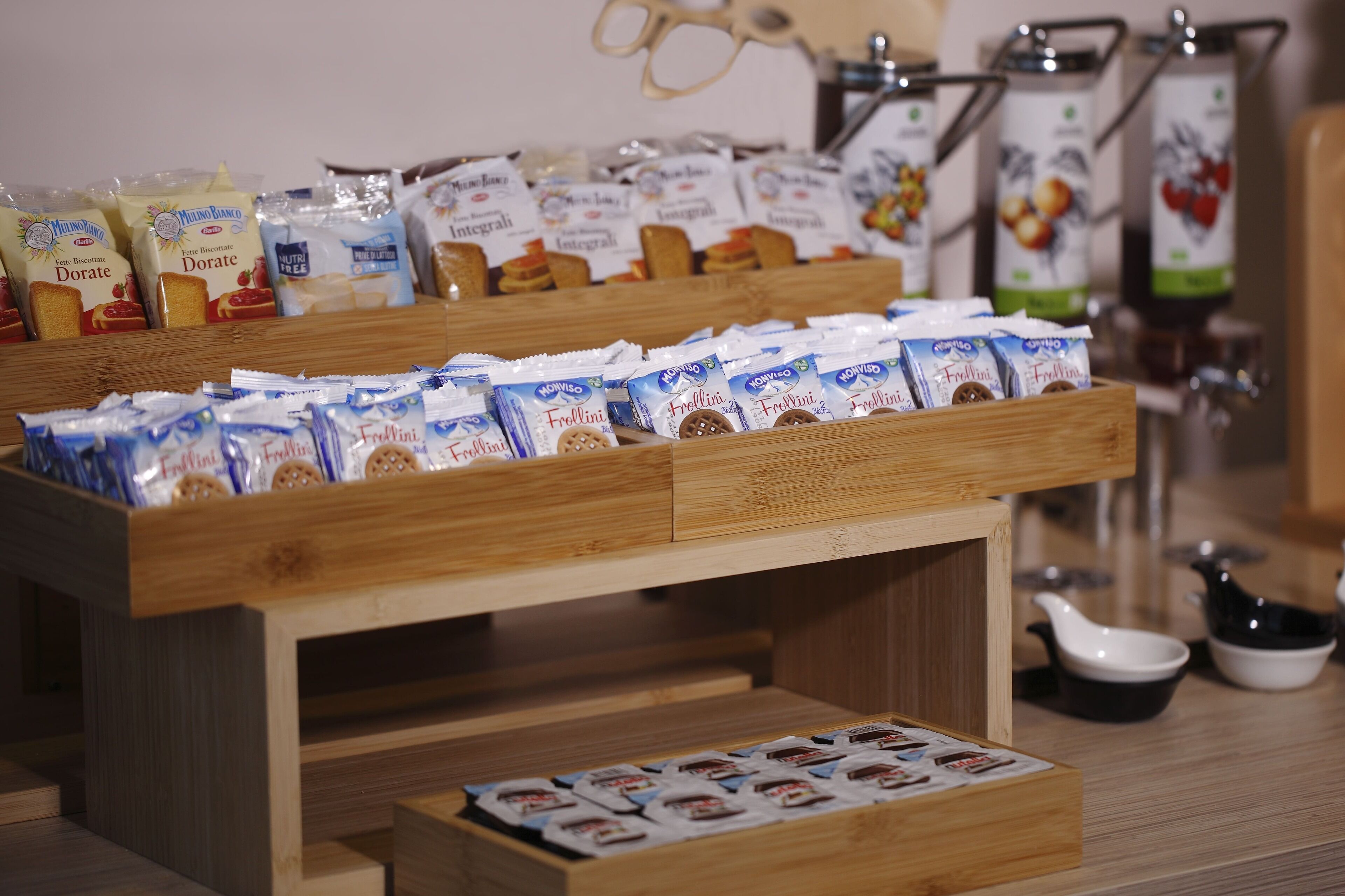 A display of packaged food items, including biscuits and coffee, arranged on a wooden table.