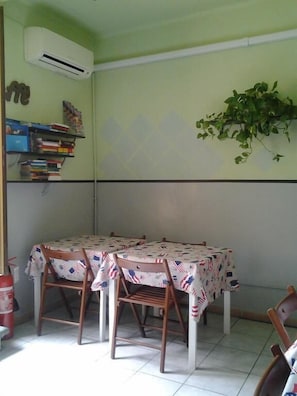 A dining area with a table covered in an American flag tablecloth, surrounded by wooden chairs. - Emerald Fields (Florence)