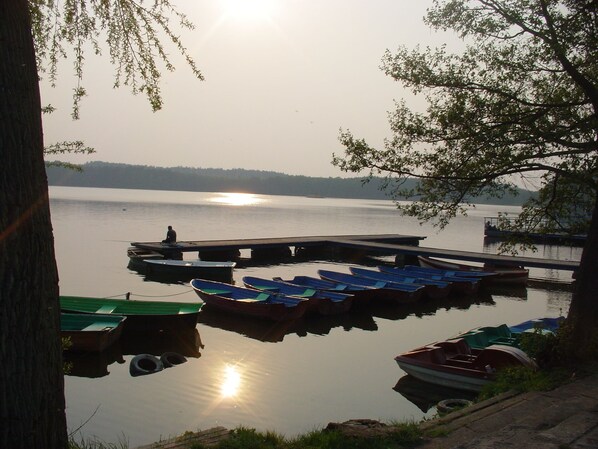 Ein ruhiger See mit Booten an einem Steg.