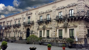 A historic building with multiple balconies and a central entrance.