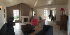 Cozy living area with a fireplace, TV, and dining space.