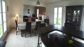 Enjoy meals with family and friends in this dining area, featuring a large table and six chairs.
