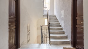 A staircase with a metal railing leading to an upper floor. - Casa Camilla, new welcoming structure to feel at home (Roma)