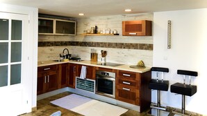 A modern kitchen with wooden cabinets, a built-in oven, and a stainless steel sink. - Adonay's house, it's also your house! (Huétor Vega)