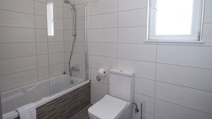 A bathroom with a bathtub, toilet, and a window. - Villa Desi, Luxury and new 5BDR Protaras Villa with pool and stunning sea views (Protaras)