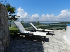 Relax on the terrace with lounge chairs and take in the breathtaking views of the surrounding hills.
