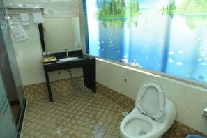 A bathroom with a toilet, sink, and a wall mural of a lake. - Quanzhou Yongchun Qiaoyou Business Hotel (Yongchun)