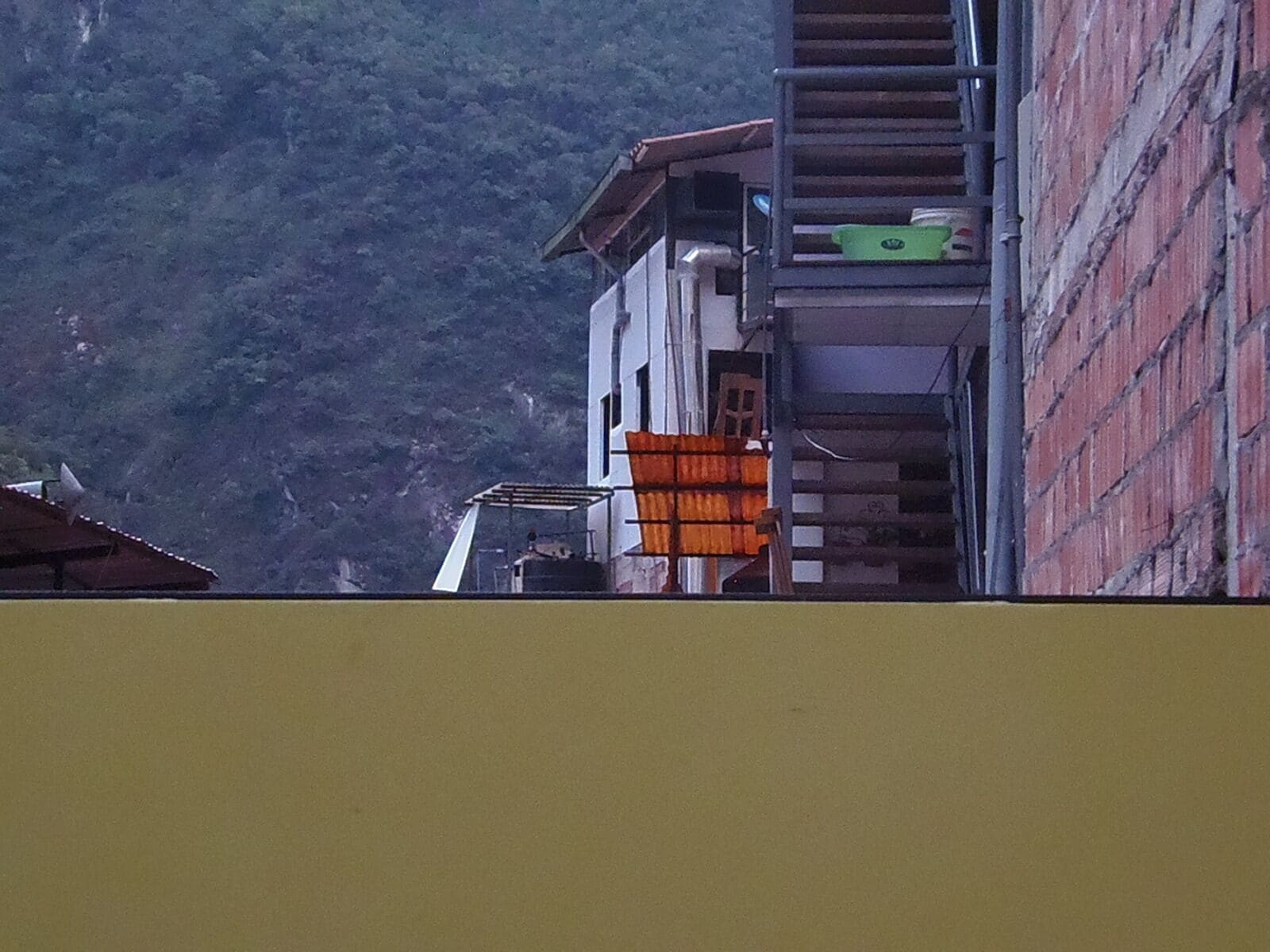 A building with a staircase leading to a balcony.