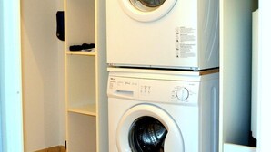 A laundry room with two stacked front-loading washing machines.