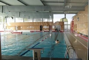 An indoor swimming pool with lanes, a starting block labeled '1', and a lifeguard chair. - Apartment with terrace Ideally Located In Quiet Residence wi-fi near beach (Quiberon)