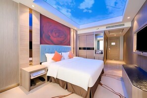 Una habitación de hotel moderna con una cama grande, televisión, armario y tragaluz.