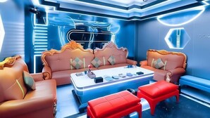 A modern living room with a sofa set, a coffee table, and red chairs. - Oriental Paris Business Hotel (Shishi)