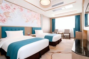 A hotel room with two beds, a large floral mural, a desk, and a TV. - Oriental Paris Business Hotel (Shishi)