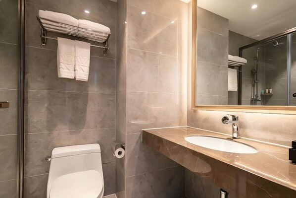 A modern bathroom with a toilet, sink, and shower. - Oriental Paris Business Hotel (Shishi)