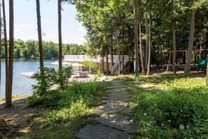 A pathway leading to a dock, surrounded by trees and greenery. - Sandy Shores on Lake Joe (Minett)
