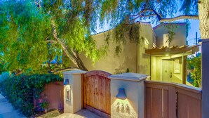 A gated entrance with a wooden gate, a mailbox, and a house number. - Experience coastal charm near Moonlight State Beach (Encinitas)