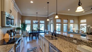 A spacious kitchen with granite countertops, stainless steel appliances, and pendant lighting. - Close to Golf Course, Pool, Beach, Baytowne!  Large home (2153 Sq Ft)- Peace of Heaven at Villa Lago (Miramar Beach)