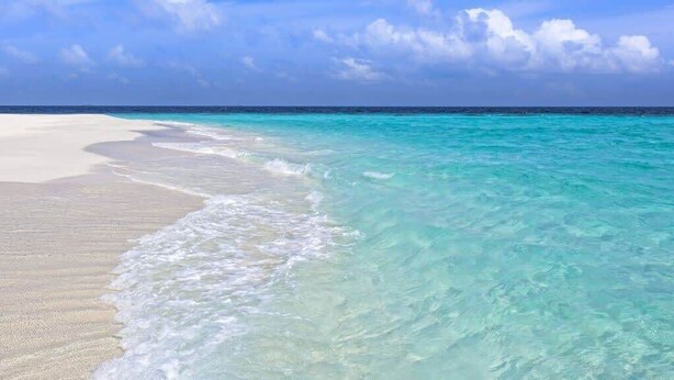A beach with clear turquoise water and white sand. - Close to Golf Course, Pool, Beach, Baytowne!  Large home (2153 Sq Ft)- Peace of Heaven at Villa Lago (Miramar Beach)