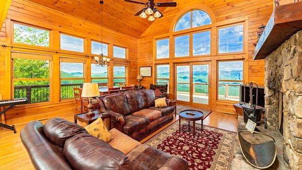 A spacious wooden cabin with a large living area, leather sofas, a fireplace, and large windows offering scenic views. - Near Asheville, near the stars, nearly perfect!  Almost Heaven.  3000 ft. (Old Fort)