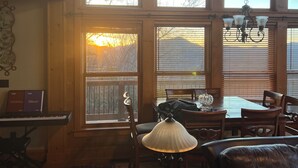 A cozy living room with a piano, a table with a lamp, and a leather couch. - Near Asheville, near the stars, nearly perfect!  Almost Heaven.  3000 ft. (Old Fort)