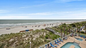 A beach resort with a swimming pool, beach access, and a lifeguard tower. - Oceanfront Beach Chic Condo, Jacuzzi Tub, Outdoor Pool | Crescent Shores - N 302 (North Myrtle Beach)