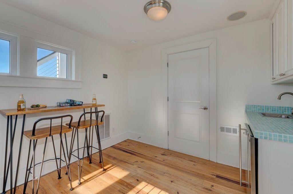 A kitchen with a wooden countertop, a sink, and a window above the counter.