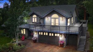 Une maison à deux étages avec un balcon, une véranda et un garage.