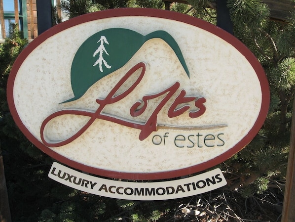 A sign for 'Lofts of Estes' indicating luxury accommodations.
