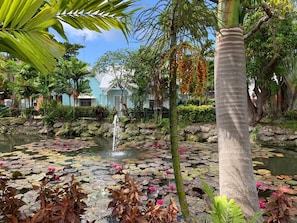A serene garden with a pond, water lilies, and a fountain. - Banyan Court, a Family-Friendly Condo Close to Everything! (Barbados)