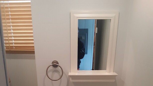 A small bathroom with a white sink, a mirror above it, and a towel ring on the wall. - Relaxing summer rental, walking distance to the beach, short ride to the outlets (Westbrook)