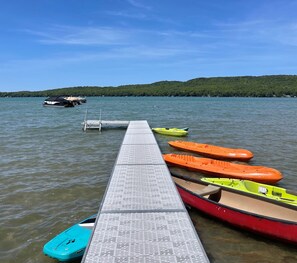 A dock with kayaks and a small boat. - Maple Lane Empire (Empire)