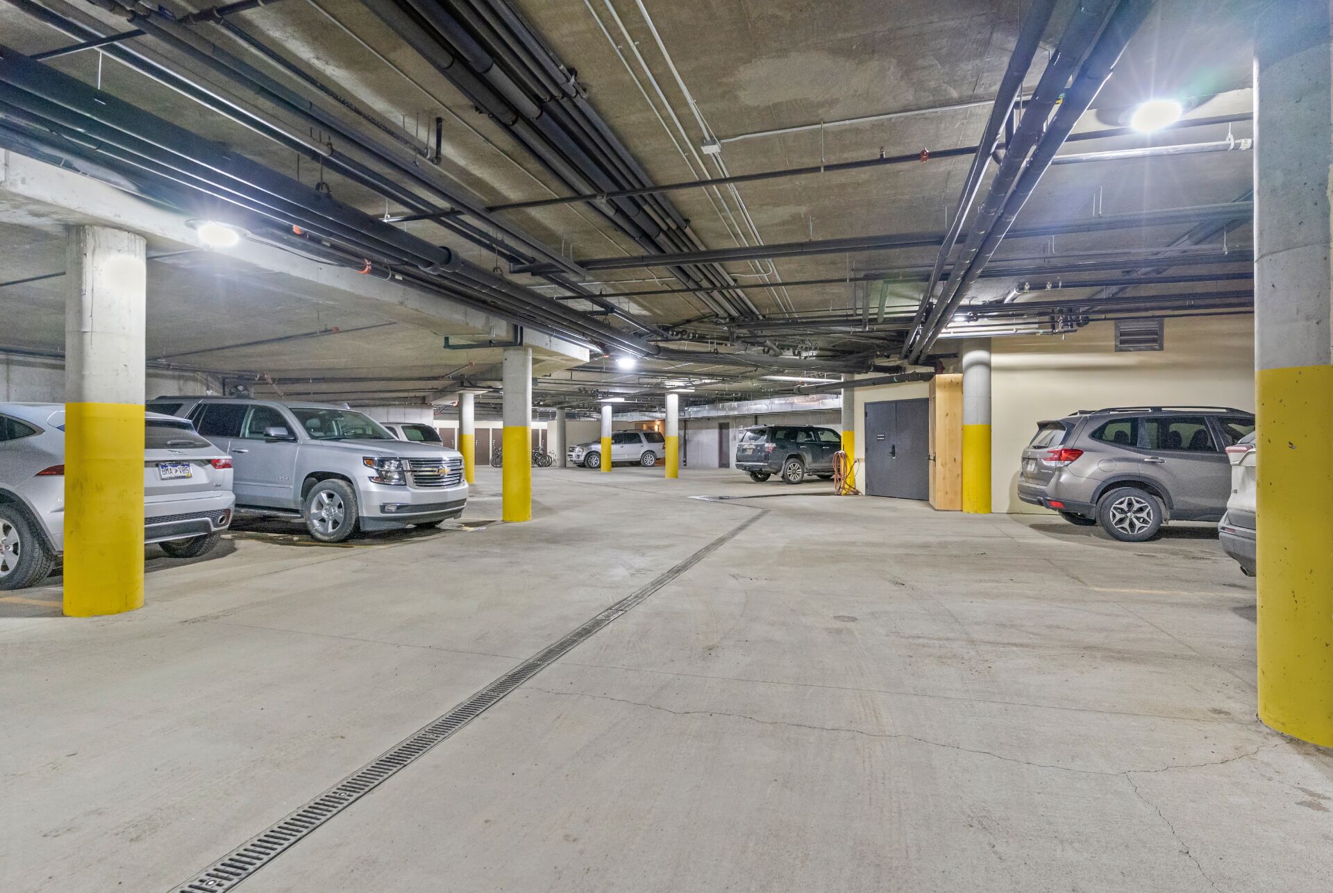 Un parking souterrain à plusieurs niveaux, où plusieurs voitures sont garées.