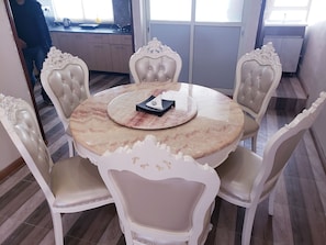 A dining area with a round marble table and six ornate chairs. - A Large brand new apartment, Kathmandu City (kathmandu)