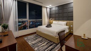 A modern bedroom with a large window, a bed, a desk, and a chair. - AMAVI LUXURY - VINHOMES SPACIOUS AND COZY APT FOR FAMILY/GROUP - 4 BR  (Ho Chi Minh)