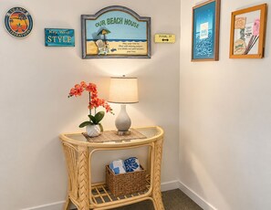 A wall with a framed sign reading 'Our Beach House' and a directional sign for 'Duvall St.' - Key West Oasis on Duval Street : Private Hot Tub • Pool • Parking • 2 Balconies (Key West)