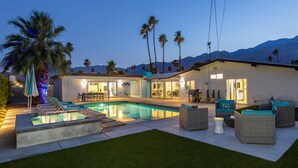 A modern house with a swimming pool, outdoor furniture, and palm trees. - Alexander Sunrise - Luxury Midcentury Retreat (Palm Springs)