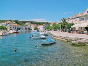Experience the tranquil atmosphere of this coastal town, where traditional architecture meets the serene harbor.