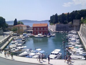 Stroll along the marina's paved walkway, surrounded by boats and scenic views of the adjacent buildings.